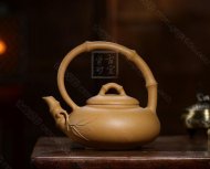 《弯把提梁》